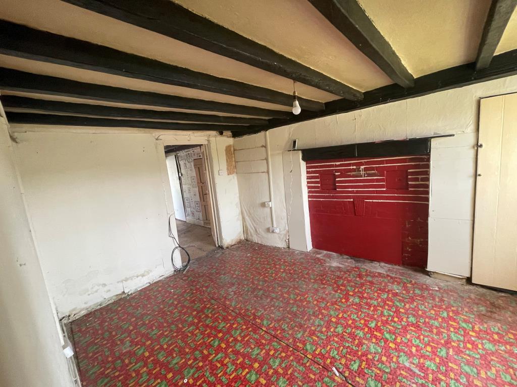 Lot: 51 - PERIOD HOUSE REQUIRING REFURBISHMENT - living room in cottage needing refurbishment